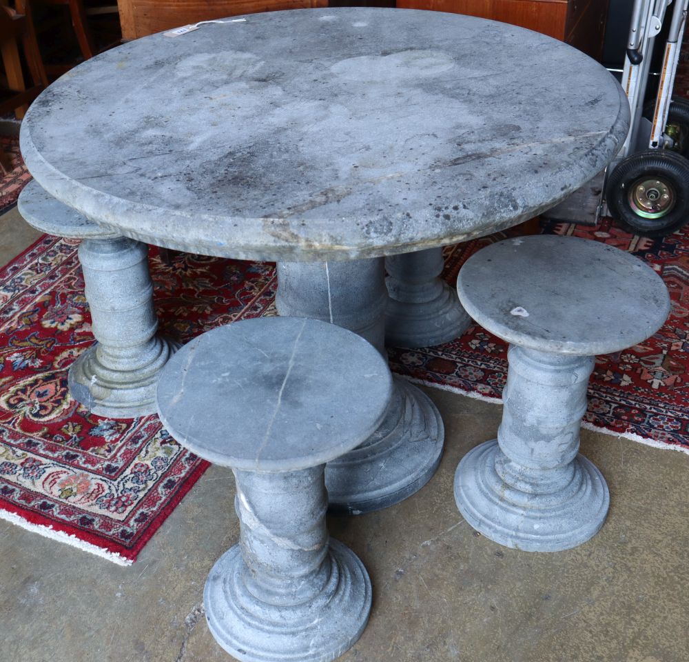 A circular reconstituted stone garden table, 100cm diameter, 80cm high and four matching stools,